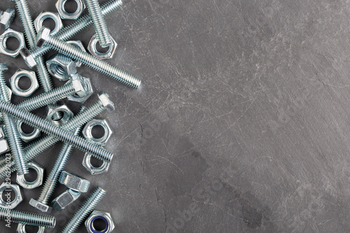 Nuts and bolts steel metal on slate base
