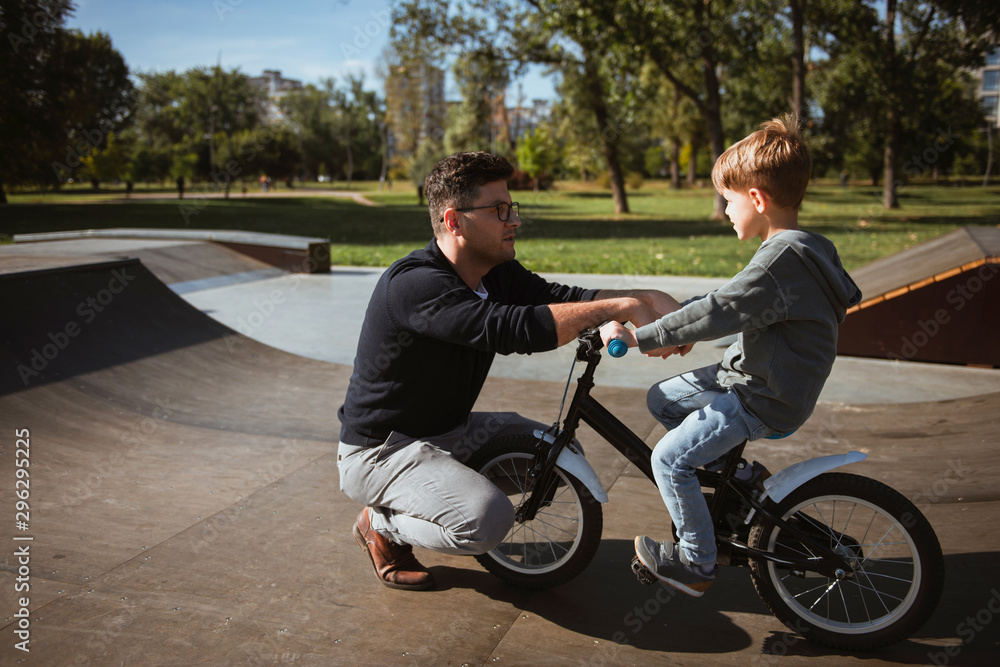 Father Learning his son to ride a bicycle Father Learning his son to ride a bicycle