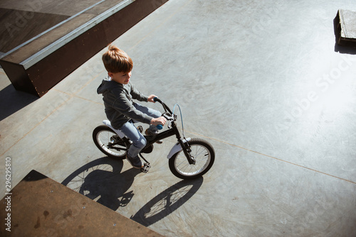 Boy riding bicycle in skate park	