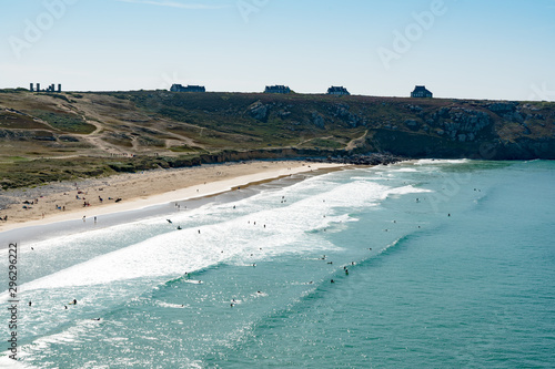 view of the Plage de Pen Hat beach and bay with many surfers