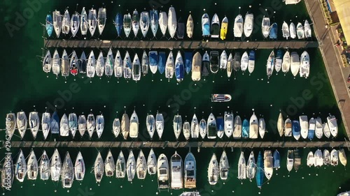 Aerial drone flight over boat goes to parking place at yacht club, Geneva, Switzerland, 4k