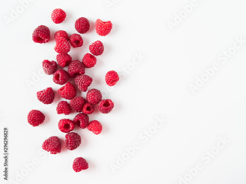 Vászonkép Heap of fresh ripe red raspberries on white background