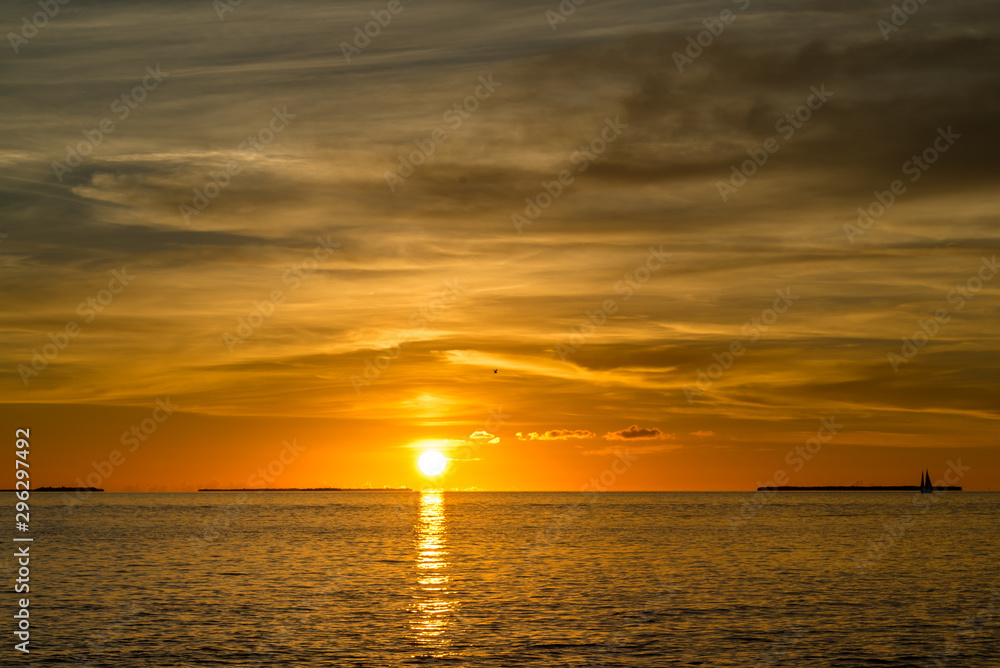 Colorful orange beautiful sunset on sea summer background. Hot and romantic sunset over the ocean. Calm landscape.