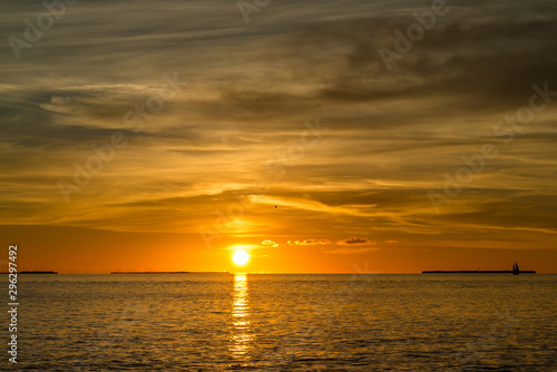 Colorful orange beautiful sunset on sea summer background. Hot and romantic sunset over the ocean. Calm landscape. © Iaroslav