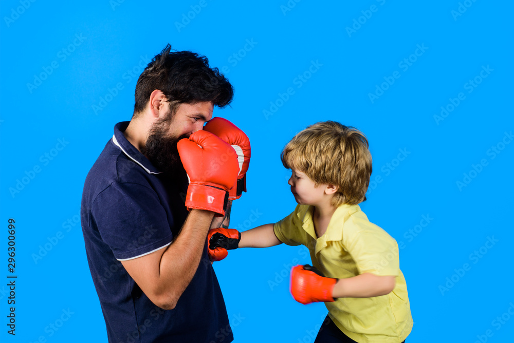 Little kickbox fighter hitting with his coach. Dad and his son in