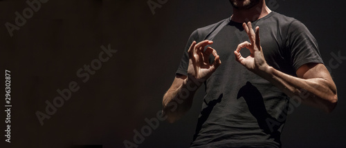 Sign language man interpreter gestures over stage during public event