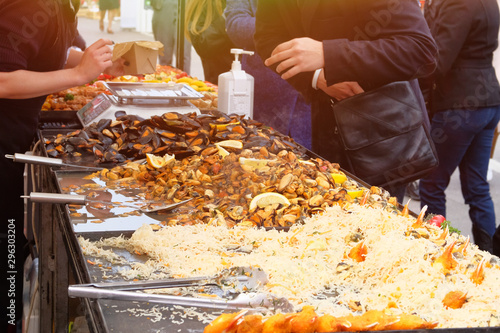 Mussels, shrimp and other seafood on street market, takeaway. Fast or street food concept. Festival of fish and seafood Cuisine.
