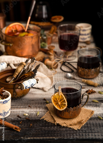 homemade mulled red wine with cinnamon, anise, cardamon and orange in glass jars