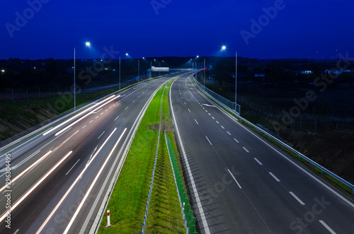 ON THE ROAD AT NIGHT - Car traffic on a modern expressway