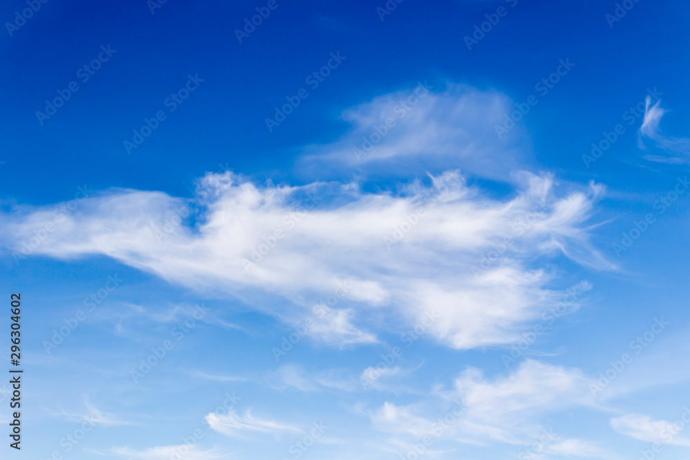 white fluffy clouds on a background of blue sky on a clear summer day