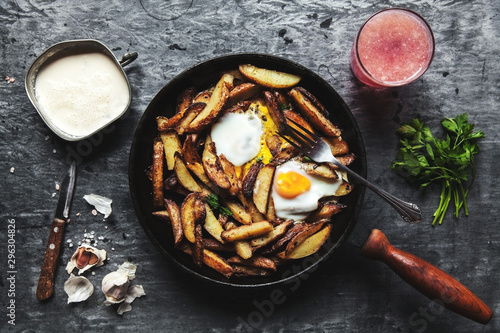 Fried potatoes and eggs in a pan close-up. horizontal