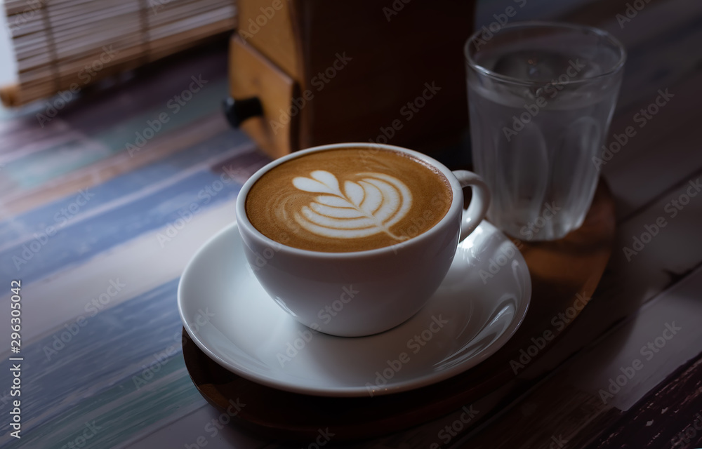 Fototapeta premium Latte Art Coffee on a wooden table in soft sunlight