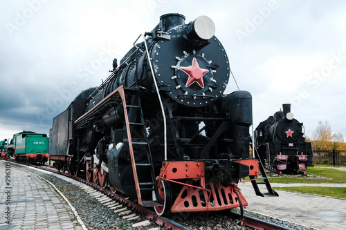 Old Russian locomotive. Steam locomotive with red wheels. Retro locomotive on rails. Black locomotive..