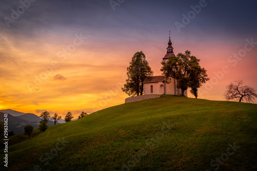 Colorful sunset over mountains with church on the hill in Slovenia © MKozloff