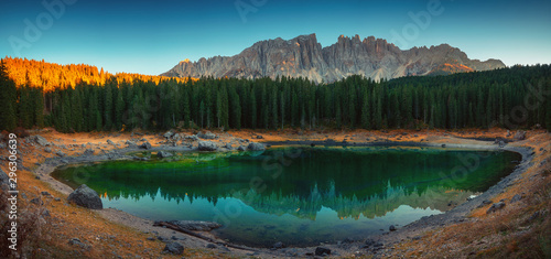 Carezza lake in Dolomitesn  or Lago di Carezza with reflection of mountains at sunset in the Dolomites, South Tyrol, Italy. photo