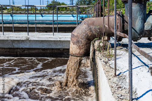 Treatment plant. City sewer. Water flows from the pipes. Environmental pollution.