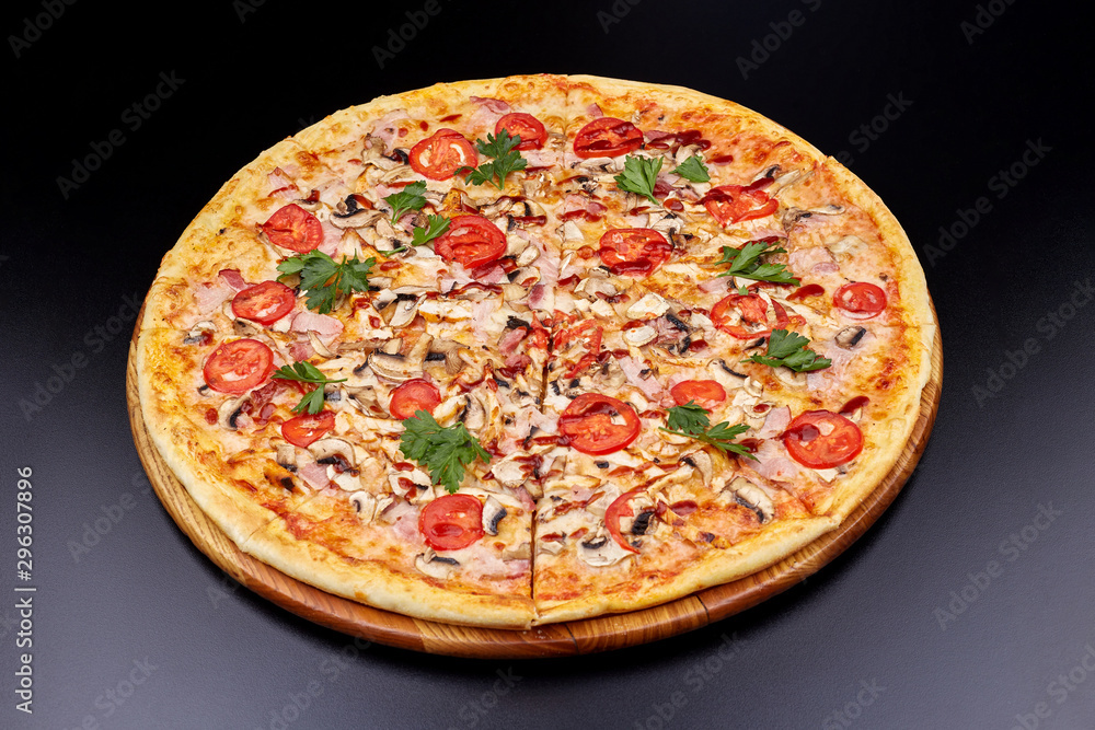 Fresh pizza with BBQ sauce on wooden cutting board. isolated on dark background.