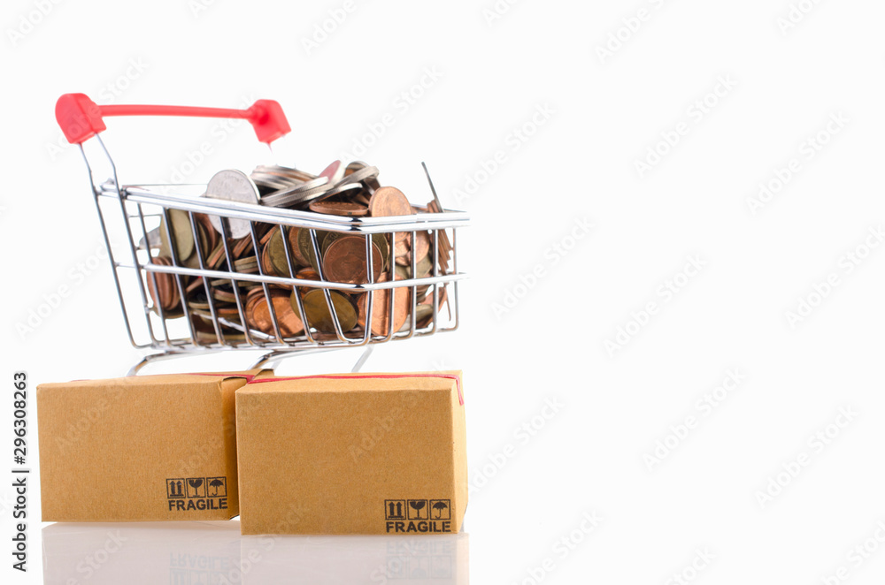 Coin in a trolley and Paper boxes on white background. Ideas online shopping is a form of electronic commerce that allows consumers to directly buy goods from a seller over the internet.
