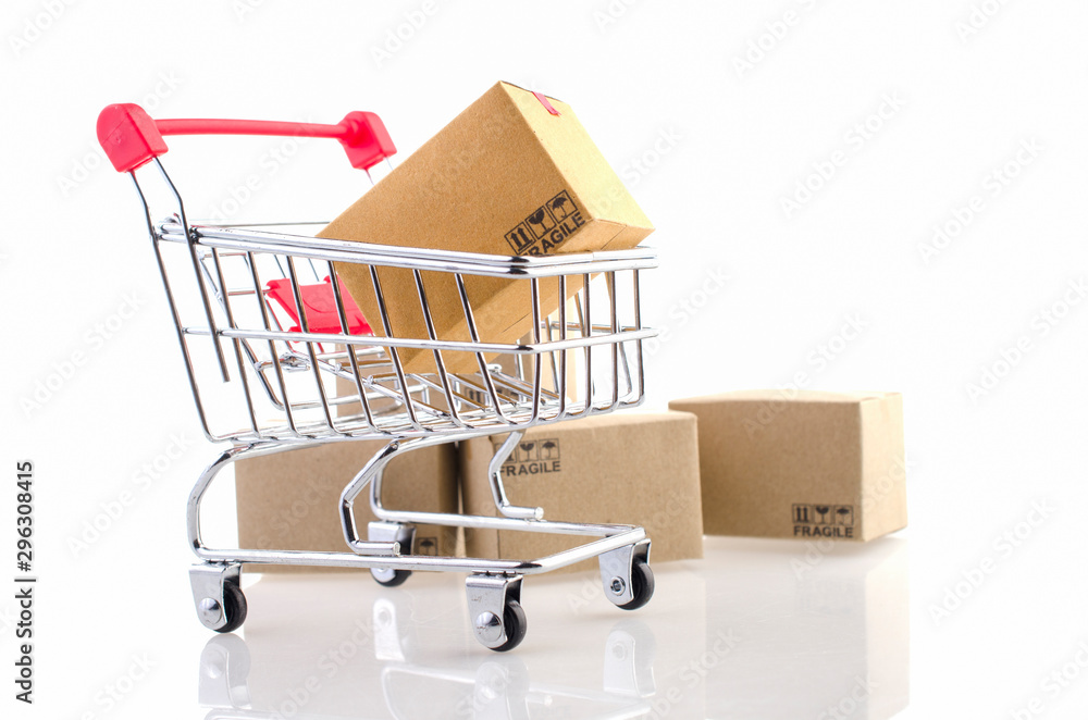 Paper boxes in a trolley on white background. Ideas online shopping is a form of electronic commerce that allows consumers to directly buy goods from a seller over the internet. Paper boxes in a trolley on white background. Ideas online shopping is a form of electronic commerce that allows consumers to directly buy goods from a seller over the internet.