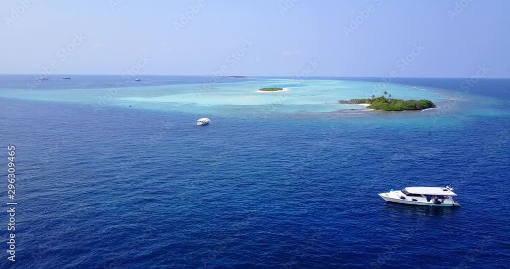 Aerial view of boats and small islands in the tropics floating on bright blue clean water in the Philippines Aerial view of boats and small islands in the tropics floating on bright blue clean water in the Philippines
