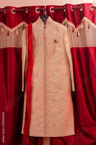  sherwani,Indian groom wedding cloth in the hanger photo