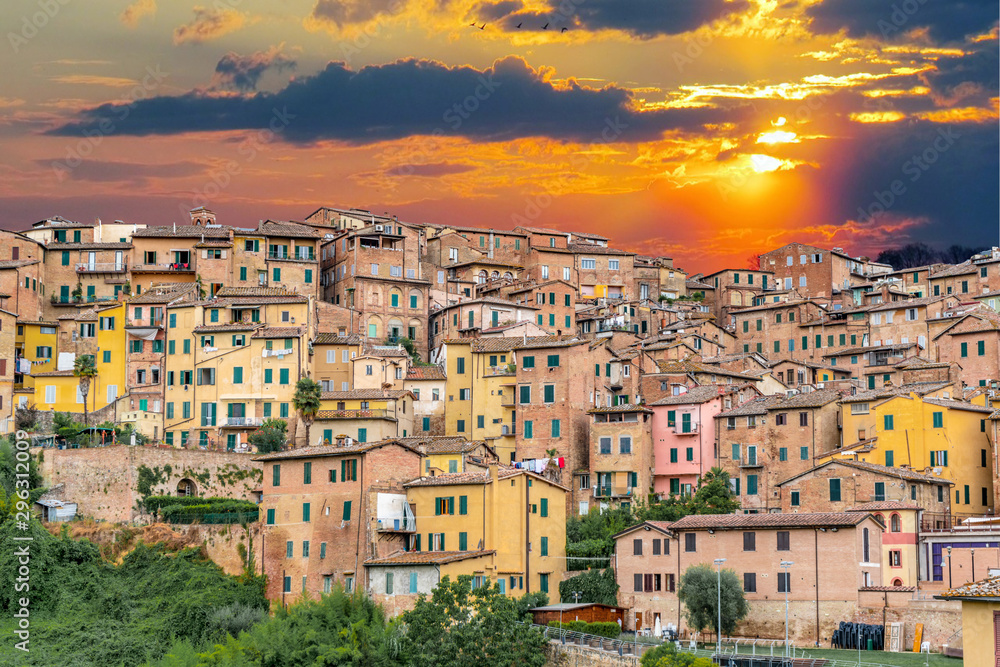 Sunset over colorful buildings in Siena Italy