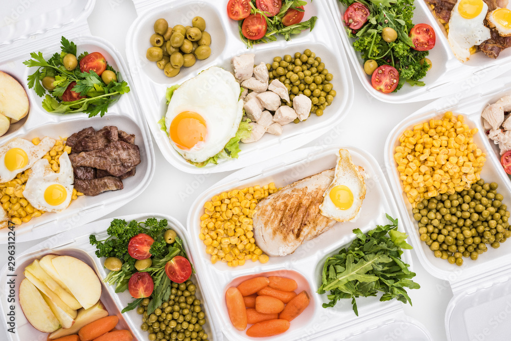top view of eco packages with apples, vegetables, meat, fried eggs and salads on white background top view of eco packages with apples, vegetables, meat, fried eggs and salads on white background