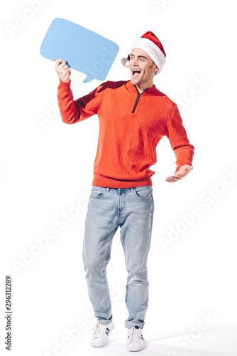 excited man in santa hat holding blue empty thought bubble, isolated on white