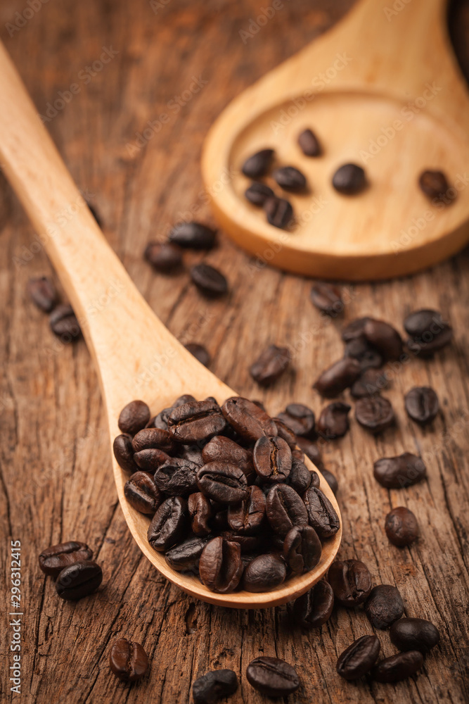 Close up coffee beans on wooden spoon Close up coffee beans on wooden spoon