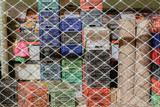 Empty storage plastic container crates stacked in market. Night view of colorful multipurpose crates stack behind store security shutter gate at Kapani Market in Thessaloniki, Greece.