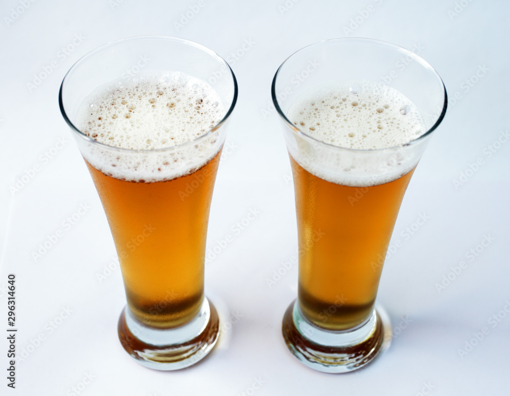 Two glasses of beer on a white background Two glasses of beer on a white background