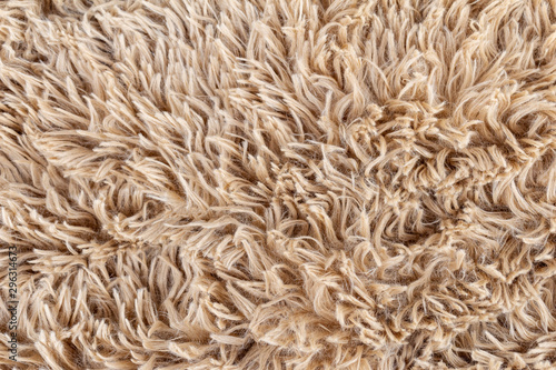 Brown soft wool background. Texture fluffy fur. Natural fur rug.
