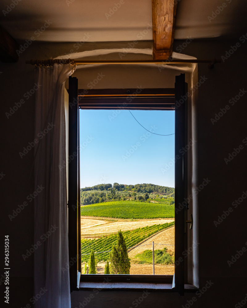 Fototapeta premium View of Crops Fields and Vineyards From Window in Tuscany Italy