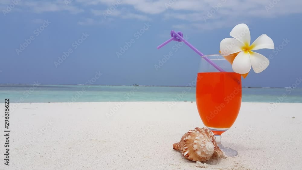 Cocktail with a flower on a tropical beach in The Maldives Cocktail with a flower on a tropical beach in The Maldives