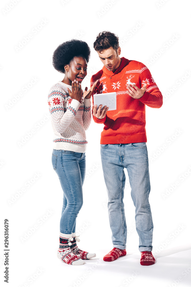 happy young interracial couple using digital tablet, isolated on white happy young interracial couple using digital tablet, isolated on white