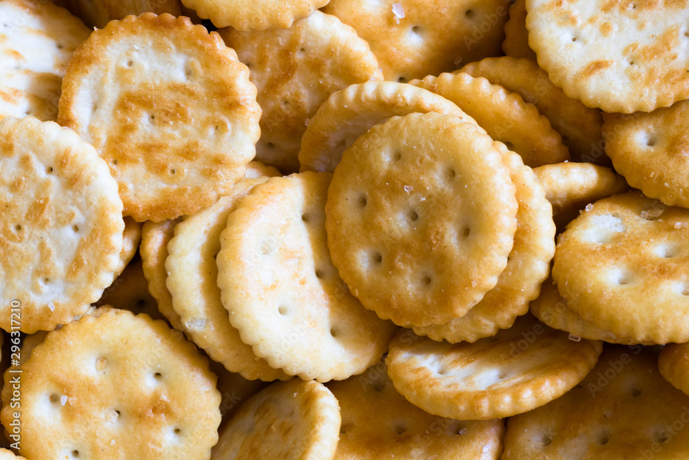 Close up on bunch of round crackers. Popular crunchy snack background.