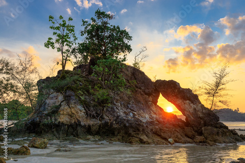 Rocky tropical coastline at sunset