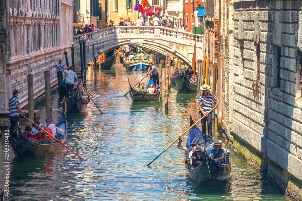 Narrow Venetian canals with gondolas riding , Venice, Italy
