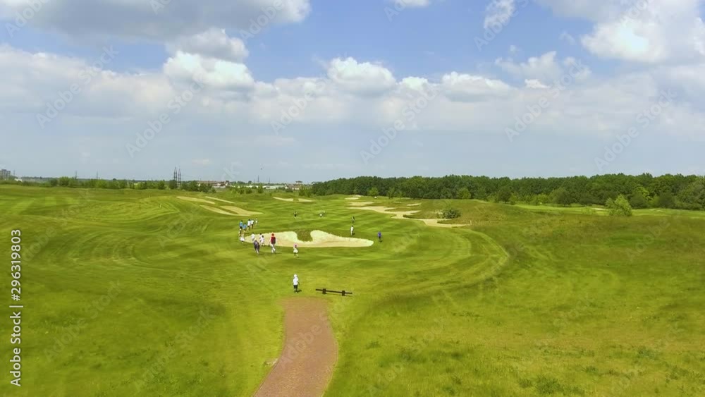 Children running on golf fields on sunny day Children running on golf fields on sunny day