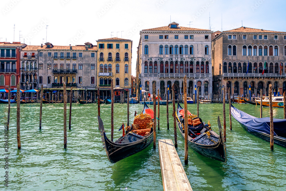 Gondolas docked at departure point near Rialto Bridge, Venice, Italy