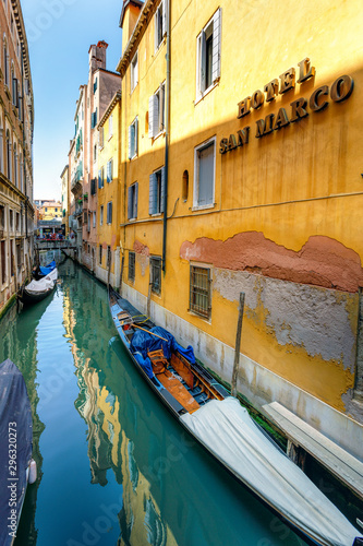 Narrow canals in Venice with docked boats near home s entrances  Italy