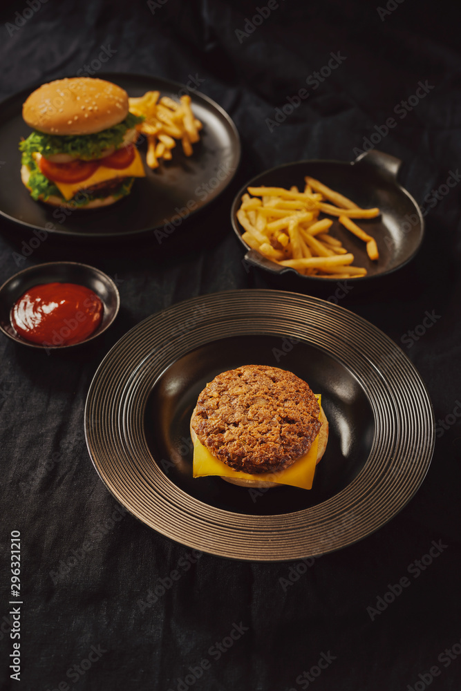 Fresh Tasty burger on dish with with french fries, ketchup