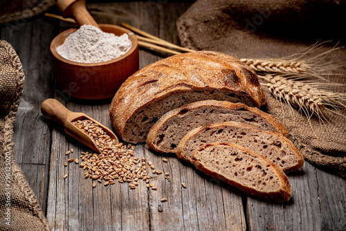 Freshly baked traditional bread on wooden table.