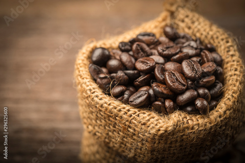 Coffee beans in sack on wood table