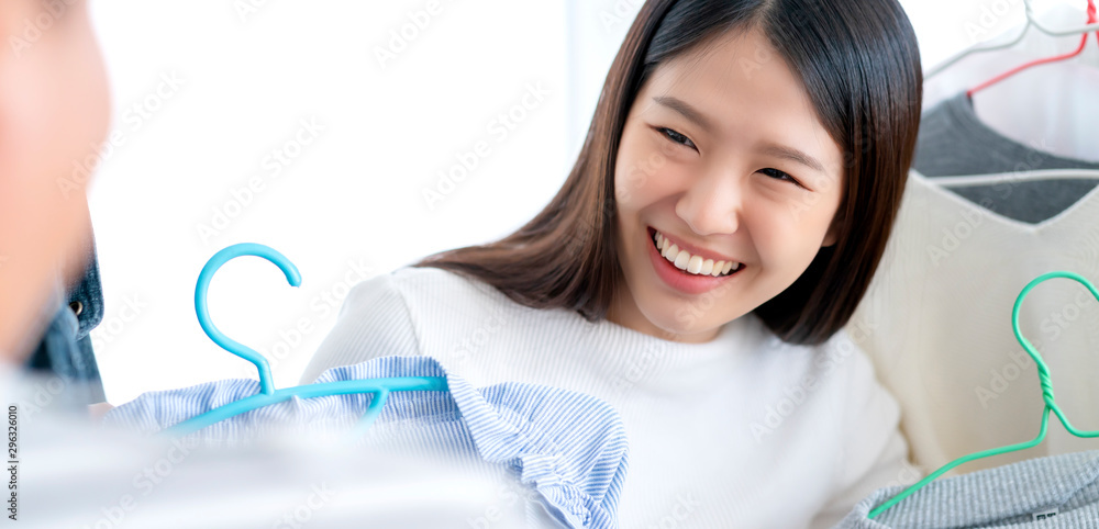 pretty happiness asian woman shopping with fun chooing cloths dress in store white room background pretty happiness asian woman shopping with fun chooing cloths dress in store white room background