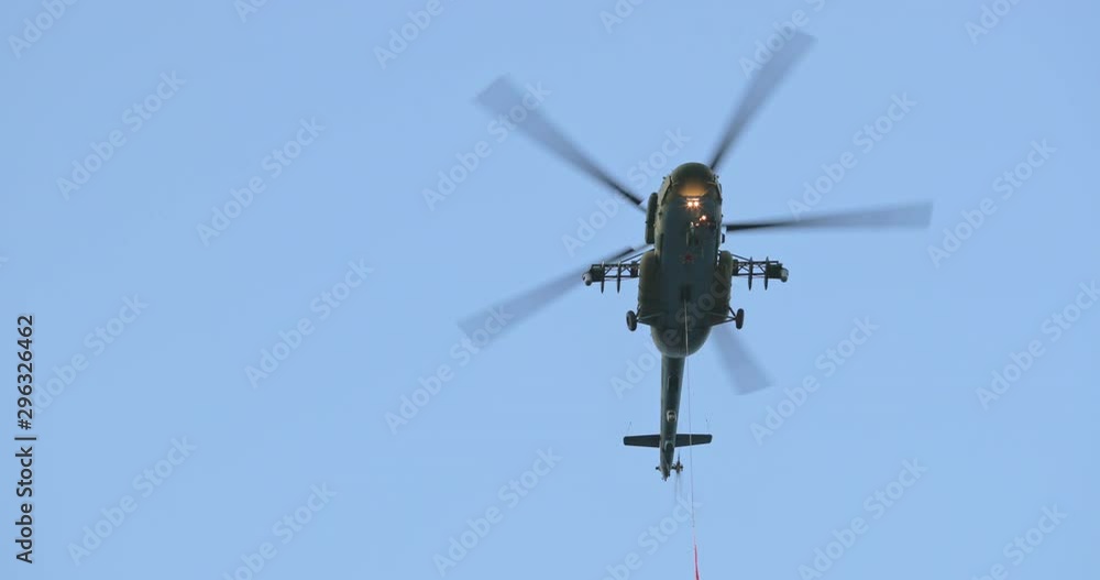 Column of four military helicopters flies over the ground. Military helicopters and planes in the evening sky. Air force parade. Independence Day parade in the CIS country. Belarus 3 July 2019. Column of four military helicopters flies over the ground. Military helicopters and planes in the evening sky. Air force parade. Independence Day parade in the CIS country. Belarus 3 July 2019.