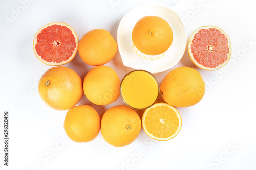 Fresh orange juice in glass on white yellow background