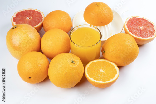 Fresh orange juice in glass on white yellow background