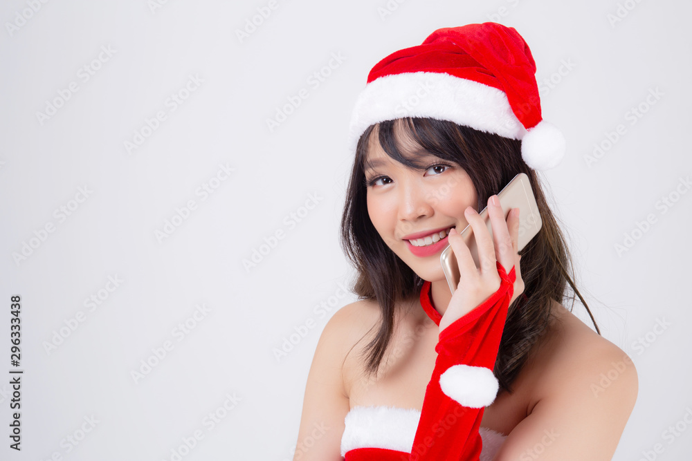Beautiful portrait young asian woman in Santa talking smartphone in xmas day isolated on white background, asia girl speak and conversation with phone in Christmas holiday, communication concept.