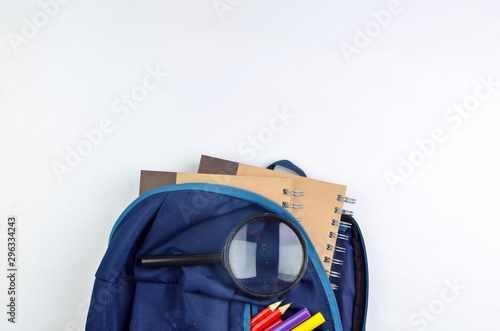 View of flat lay with school backpack and stationery with space for text on white background. Selective focus.